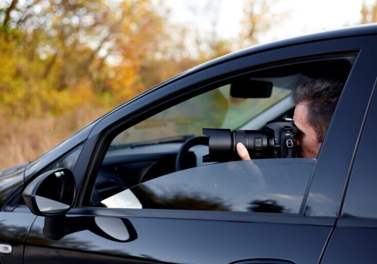 Young man with a dslr camera in a car.